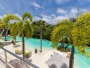 Outdoor swimming pool with palm trees and clear blue sky