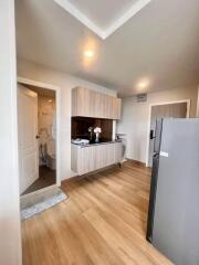 Small modern kitchen with wooden flooring and gray cabinets