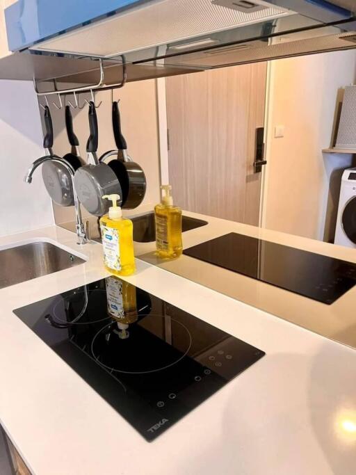 Modern kitchen with stove and hanging pots