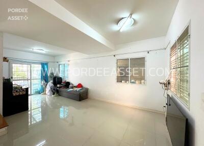 Spacious main living area with modern lighting and large windows