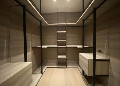 Spacious walk-in closet with built-in shelving and drawers