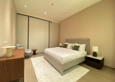 Spacious modern bedroom with large bed and contemporary furnishings