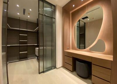 Modern walk-in closet with custom cabinetry and vanity area