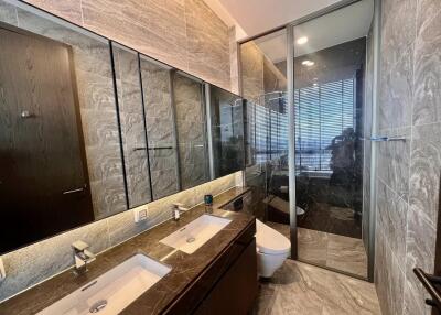 Modern bathroom with glass shower and dual sinks