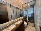 Modern bathroom with glass shower and dual sinks