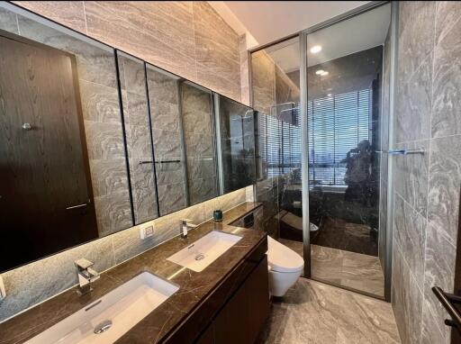 Modern bathroom with glass shower and dual sinks