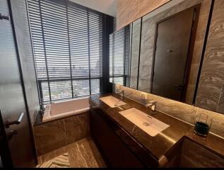 Luxurious bathroom with double sinks and large windows