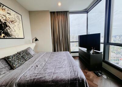 Modern bedroom with large windows and city view