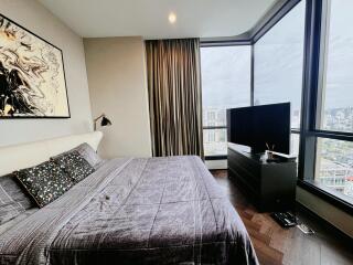 Modern bedroom with large windows and city view