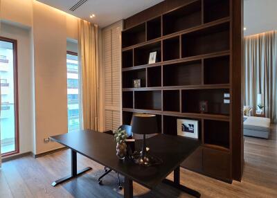 Modern home office with large bookshelf and window