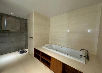 Modern bathroom with bathtub and built-in shelving