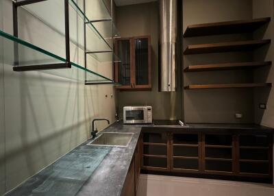 Modern kitchen with sleek counters and shelving