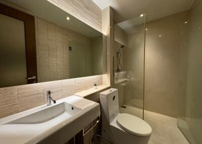 Modern bathroom with sink, toilet, and shower