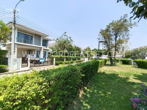 Front view of a residential building with garden