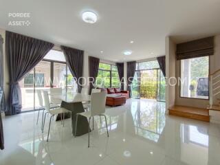 Modern living and dining area with large windows