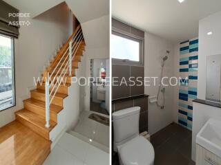 Stairs leading up and modern bathroom with shower