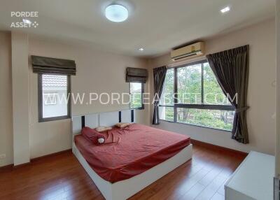 Spacious bedroom with large windows and a double bed