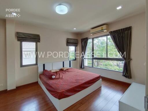 Spacious bedroom with large windows and a double bed