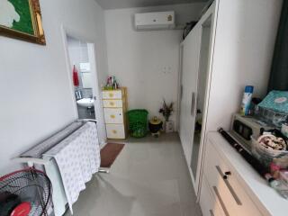 Organized bedroom with wardrobes and laundry rack