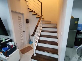 Modern staircase with wooden steps and metal railings