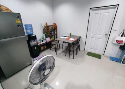 Kitchen area with dining table and appliances