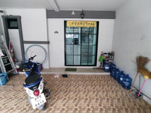 Covered area with motorbike and door entrance