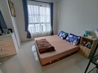 Neatly decorated bedroom with a window providing natural light