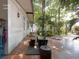 Outdoor seating area with plants and trees