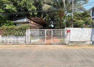 Front exterior view of the property with garden and gate