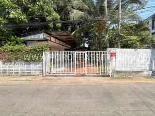 Front exterior view of the property with garden and gate