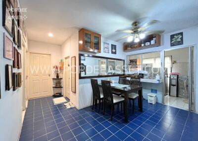 Dining area in a kitchen with blue tile flooring and a ceiling fan