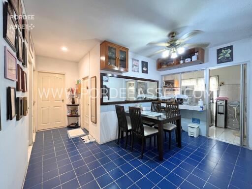 Dining area in a kitchen with blue tile flooring and a ceiling fan