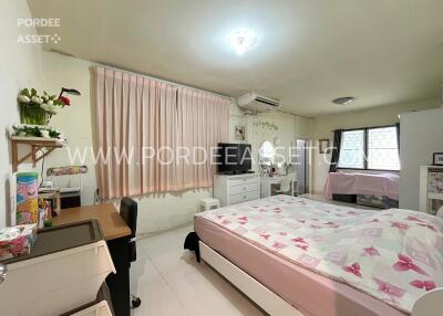 Cozy bedroom with natural light and comfortable furnishings