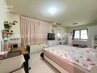 Cozy bedroom with natural light and comfortable furnishings