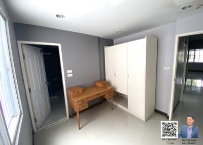 Bedroom with wooden desk and white wardrobe