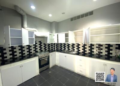 Modern kitchen with black and white tiled backsplash