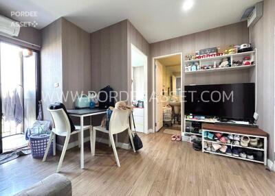 Cozy modern bedroom with desk, shelf, and TV