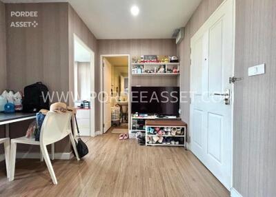 Modern living room with wooden flooring and TV setup