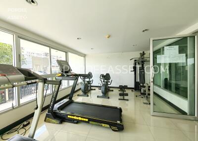 Gym with exercise equipment and large windows