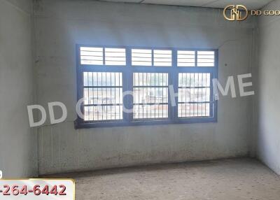 Empty room with barred windows and concrete walls