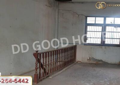 Living room with worn-out walls and simple railing