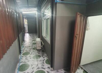 Exterior hallway with windows and decorated floor tiles