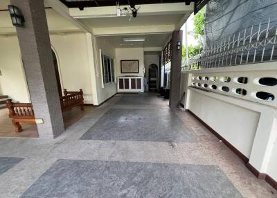 Spacious covered outdoor area with bench and fenced siding