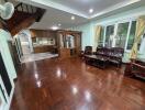 Living room with wooden furniture and connected kitchen