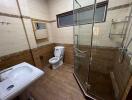 Bathroom with glass shower and toilet