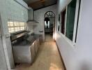 Simple kitchen with stainless steel appliances and large window