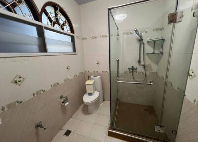 Spacious bathroom with glass shower enclosure and modern fixtures