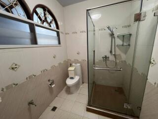 Spacious bathroom with glass shower enclosure and modern fixtures