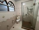 Spacious bathroom with glass shower enclosure and modern fixtures