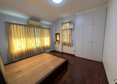 Spacious bedroom with large windows and built-in wardrobe